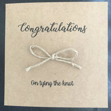 Load image into Gallery viewer, Brown  kraft card size 6&quot;x6&quot;. Congratulations is printed along the top in black. With a bow tied from Jute string in the middle and &quot;on tying the knot&quot; underneath
