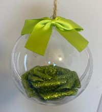 Load image into Gallery viewer, green glitter covered foam rose is set inside a clear round bauble. tied with jute string and a green bow sits on top
