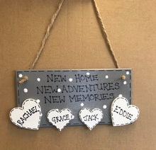 Load image into Gallery viewer, hand painted in grey this rectanglular wall plaque is 6&quot; x 3&quot;. with New home, New adventures, New memories hand written. Family Members names are written in 4cm white hearts and family pets are written on 4cm white paws. white spots pattern can be added to the grey. Hung with jute string twine
