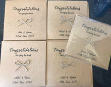 Load image into Gallery viewer, Brown kraft card size 6&quot;x6&quot;. Congratulations is printed along the top in black. With a bow tied from Jute string in the middle and &quot;on tying the knot&quot; underneath
