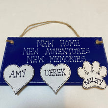 Load image into Gallery viewer, hand painted in navy this rectanglular wall plaque is 6&quot; x 3&quot;. with New home, New adventures, New memories hand written. Family Members names are written in 4cm white hearts and family pets are written on 4cm white paws. white spots pattern can be added to the navy. Hung with jute string twine
