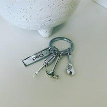 Load image into Gallery viewer, metal keyring with metal charms which include hammer,wrench,screwdriver and a ruler which is engraved with the word dad
