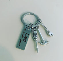 Load image into Gallery viewer, metal keyring with metal charms which include hammer,wrench,screwdriver and a ruler which is engraved with the word dad
